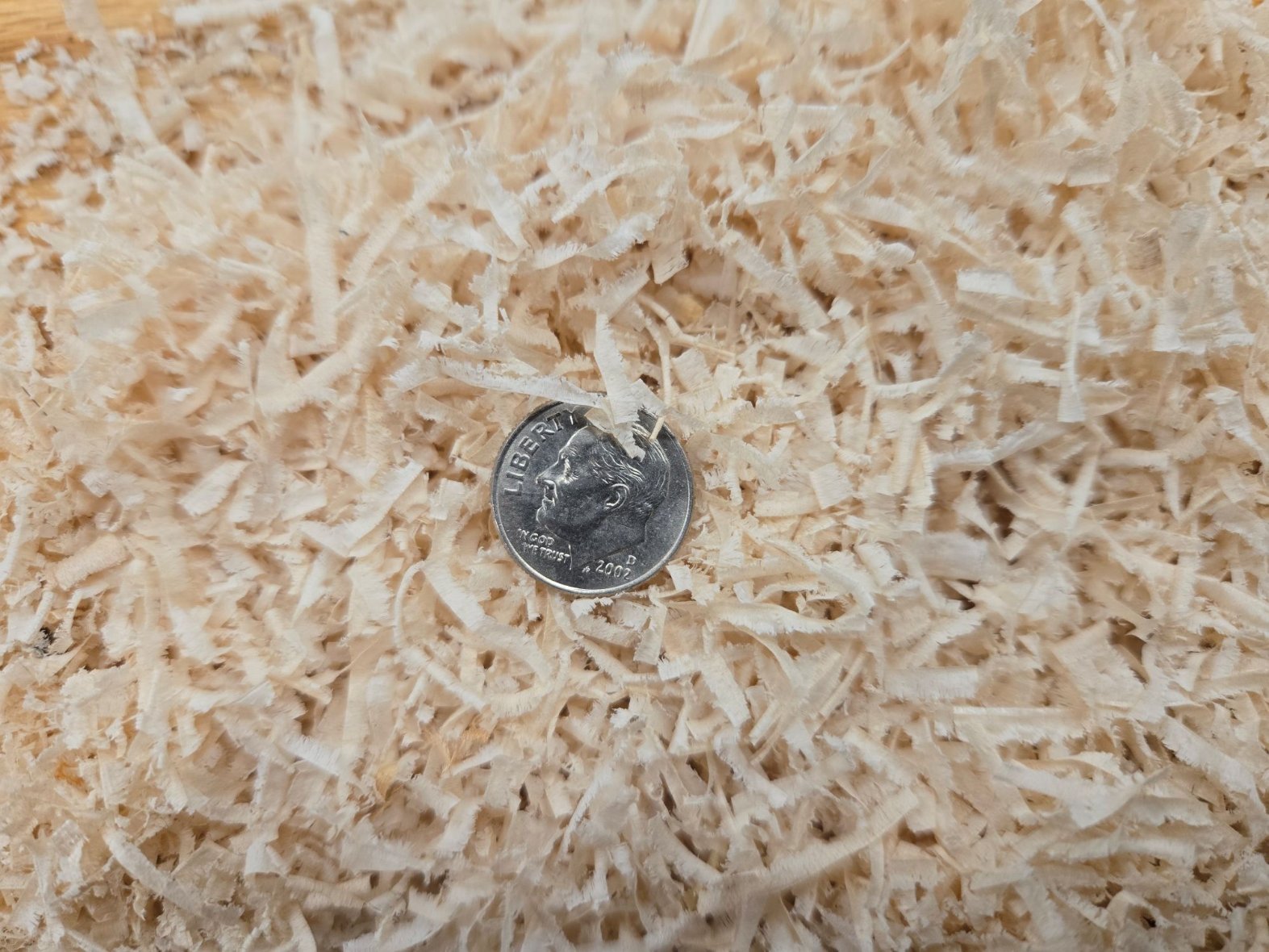 pile of extracted chips with dime for size comparison