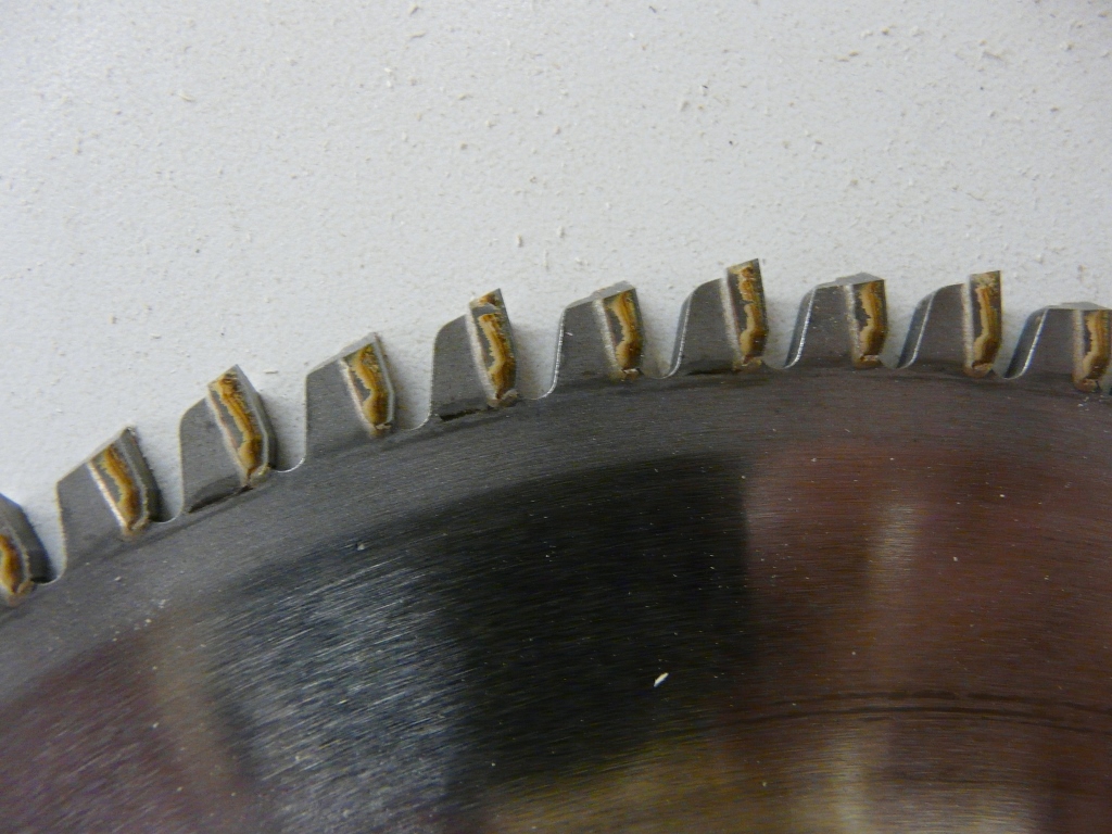 Negative rake saw blade.  I find these cut plywood very cleanly.  Careful thouugh they tend to try to lift the piece.(1).jpg