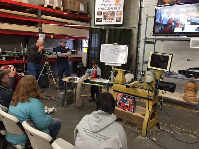 Kenny demoing turning tops.