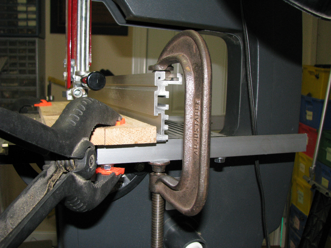Placing a 1/2" hex nut or a short piece of 3/8" high bar stock in the top T track fence extrusion should protect the track from C clamp damage.