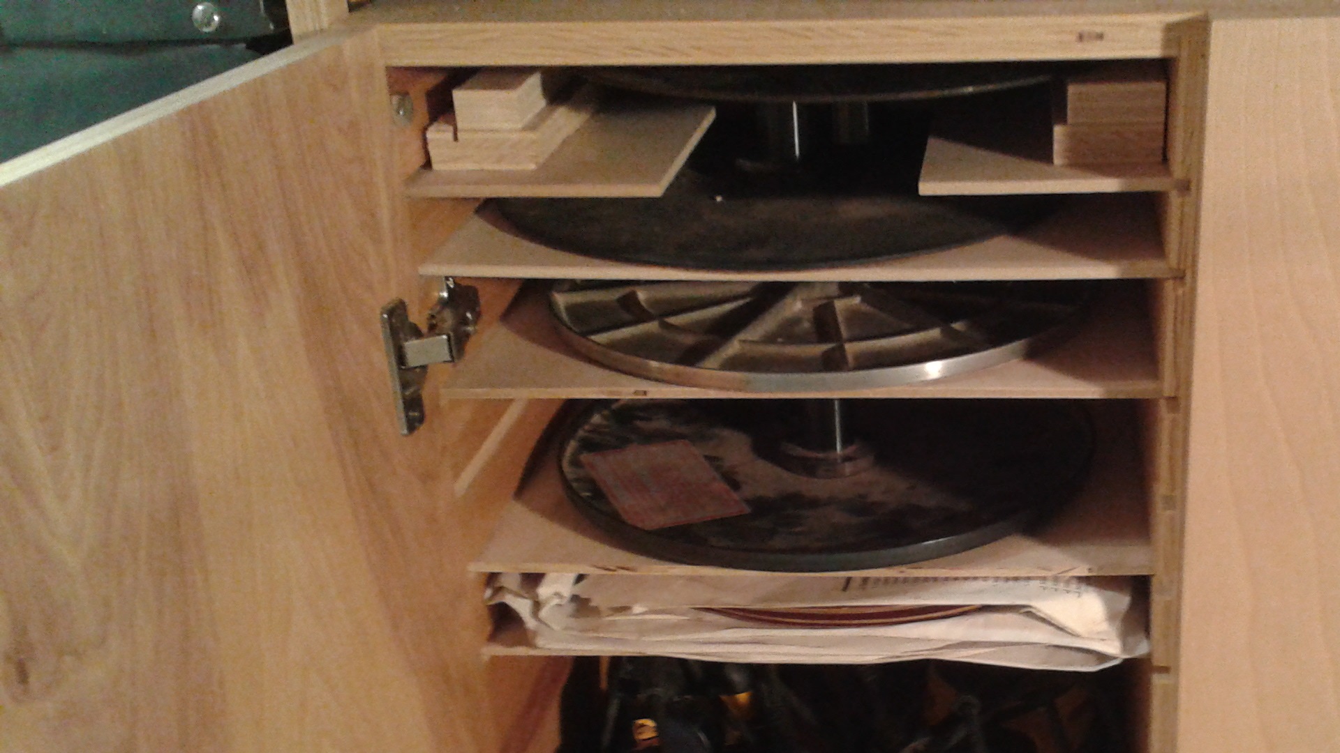 Left Cabinet with sanding discs, an orbital sander, and palm sander
