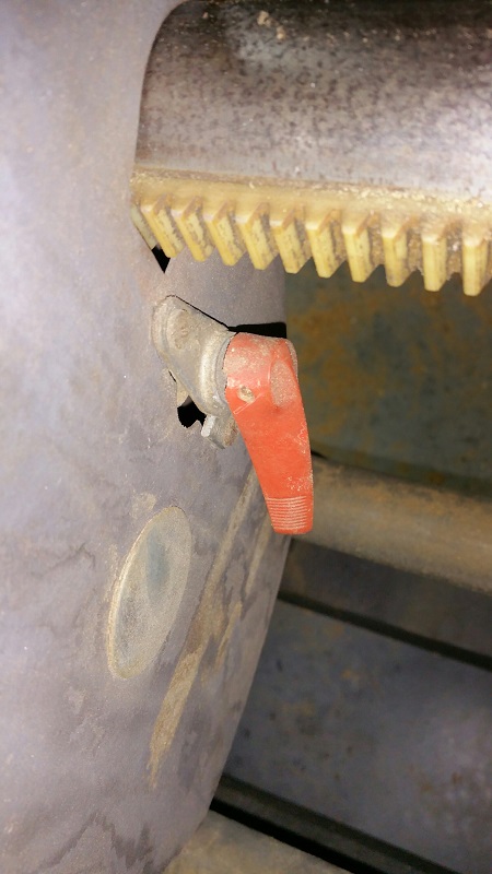 Also, what does this little red nob do? I see that it turns a little cam on the inside of the belt cover, but not sure of the function of that cam. Does it lock the headstock down? it seems a little small for that.