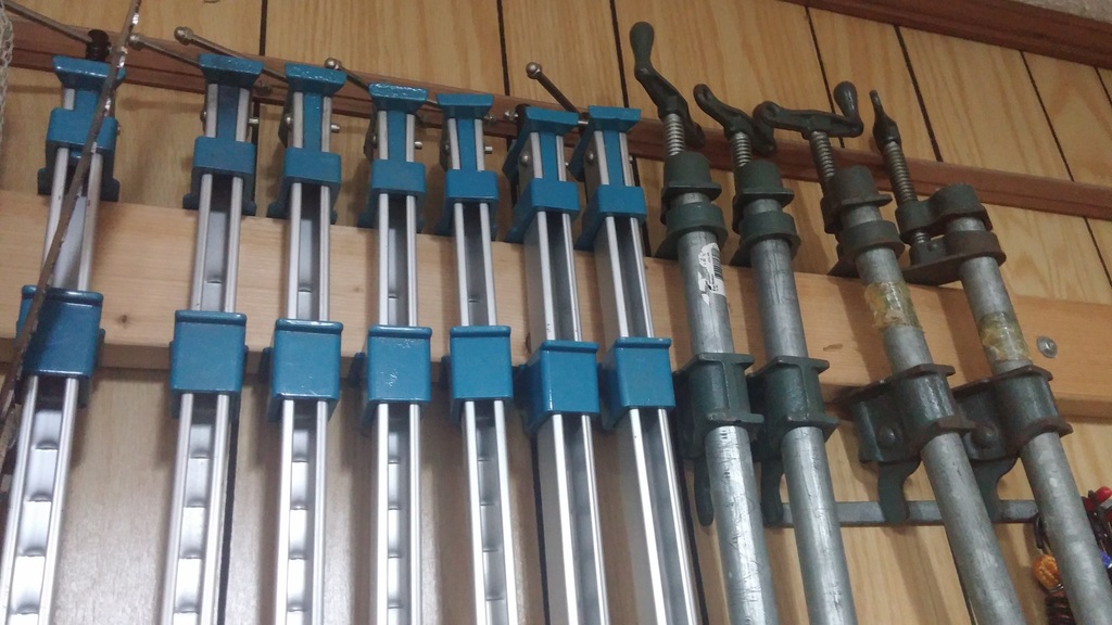 Pipe and aluminum bar clamps on a 2x4