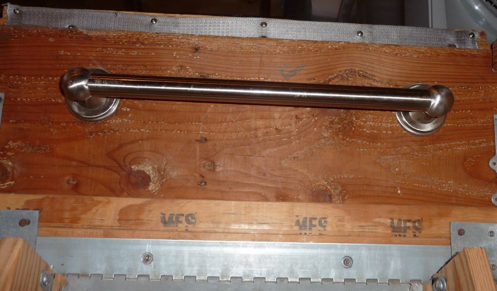 Safety grab bar attached to header.
