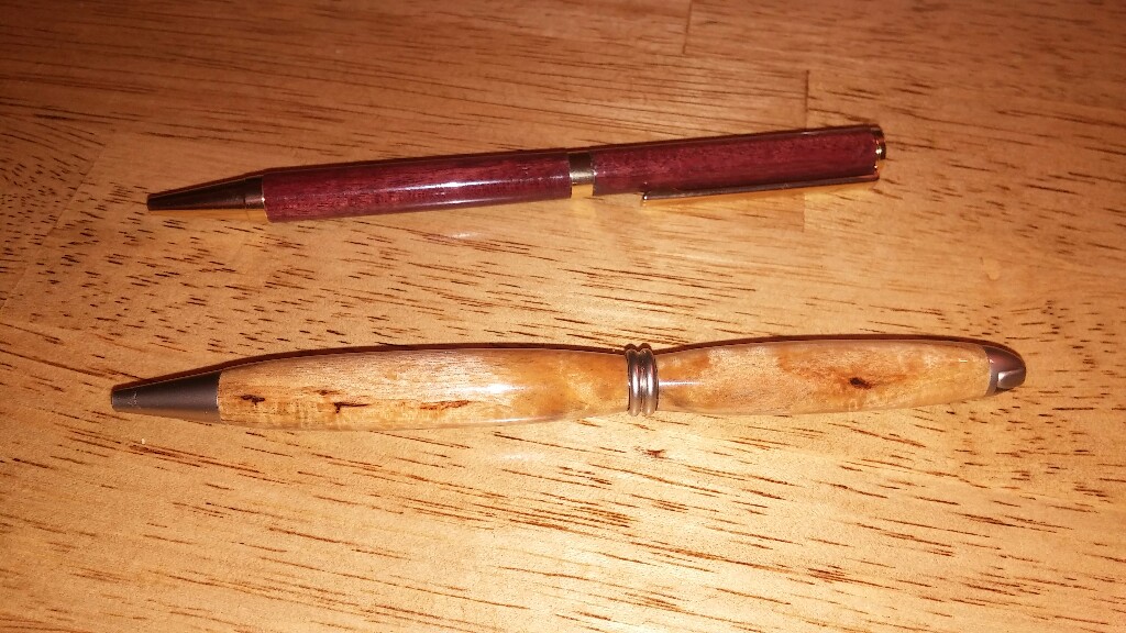 first things i turned, a purple heart pen and white birch pen made from a white birch tree from my grandma and grandpas house that i used to play in as a child